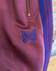 NEEDLES WIDE HD TRACK PANTS ‘MAROON/PURPLE’