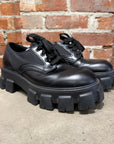 PRADA MONOLITH LEATHER DERBIES ‘BLACK’