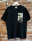 CAV EMPT WONDERLAND GRAPHIC TEE ‘BLACK’