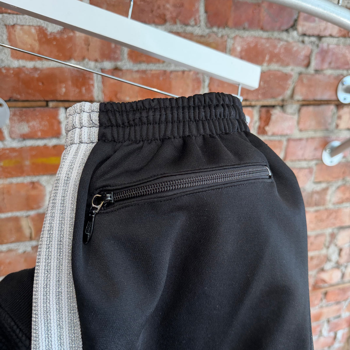 NEEDLES X AWGE TRACK PANTS ‘BLACK/SILVER’