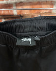 STUSSY S-LOGO WIDE TRACK PANTS ‘BLACK’