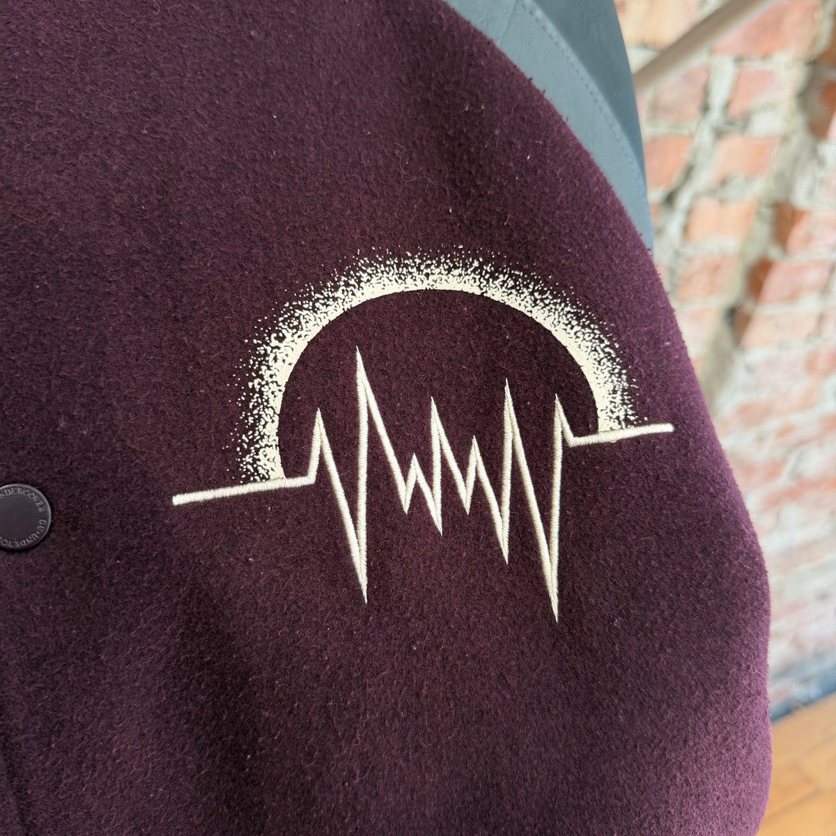 GU X UNDERCOVER KOSMIK NOISE VARSITY JACKET ‘BLACK/MAROON’