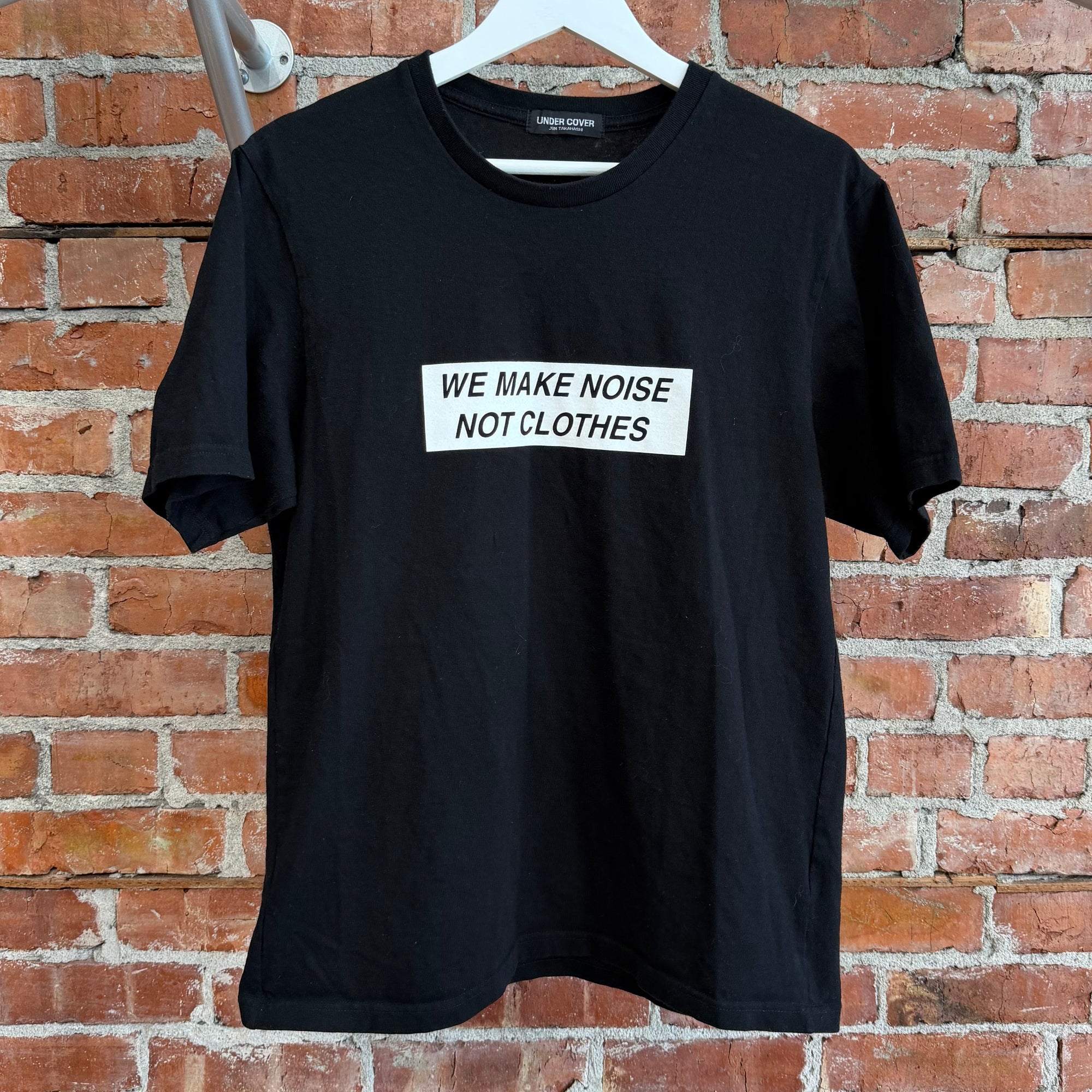 UNDERCOVER MADSTORE WE MAKE NOISE NOT CLOTHES TEE ‘BLACK’