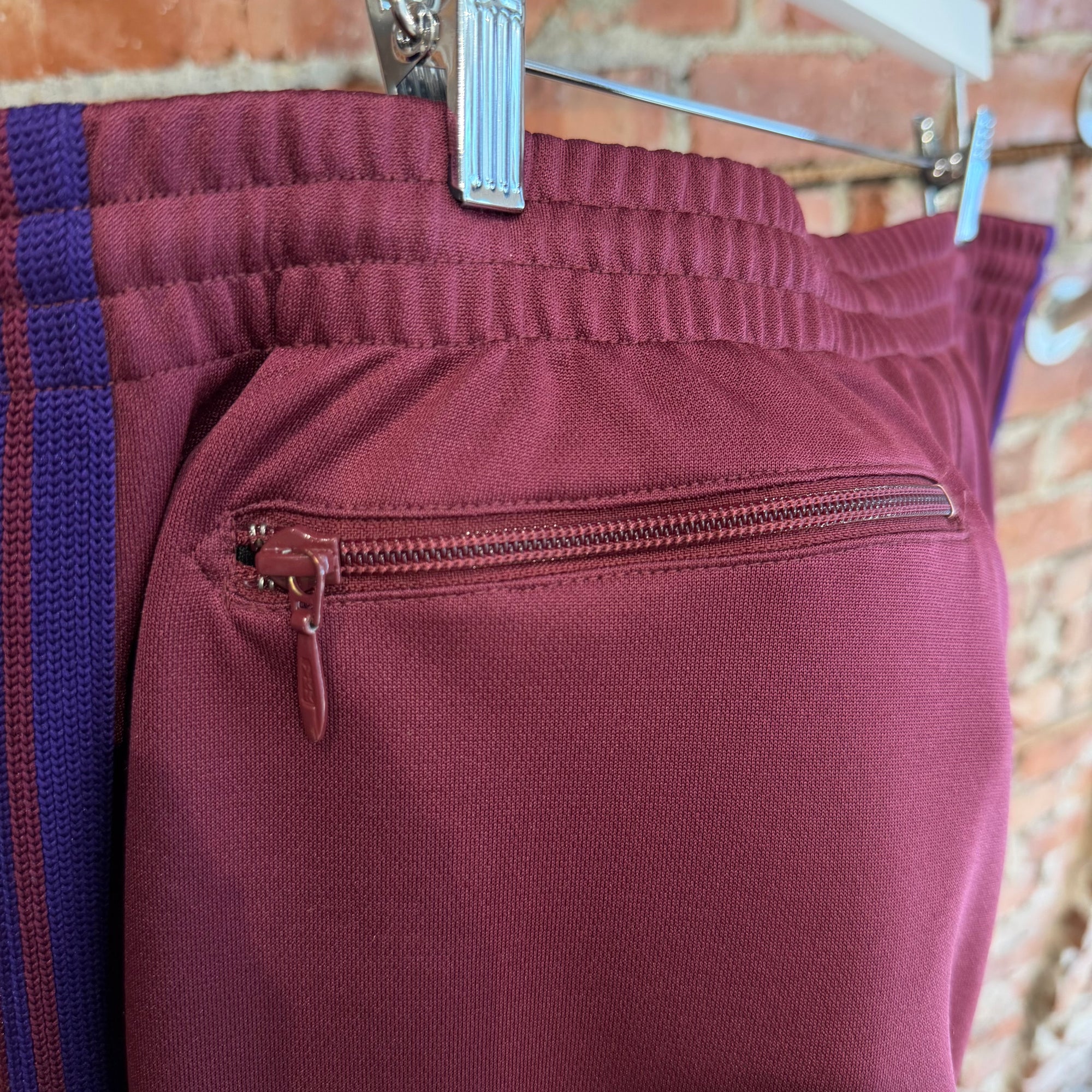 NEEDLES WIDE HD TRACK PANTS ‘MAROON/PURPLE’