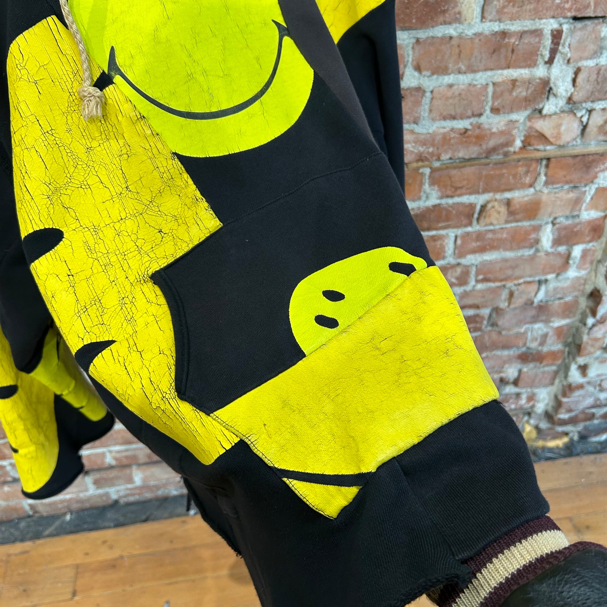 KAPITAL RECONSTRUCTED PATCHWORK SMILEY HOODIE ‘BLACK/YELLOW’