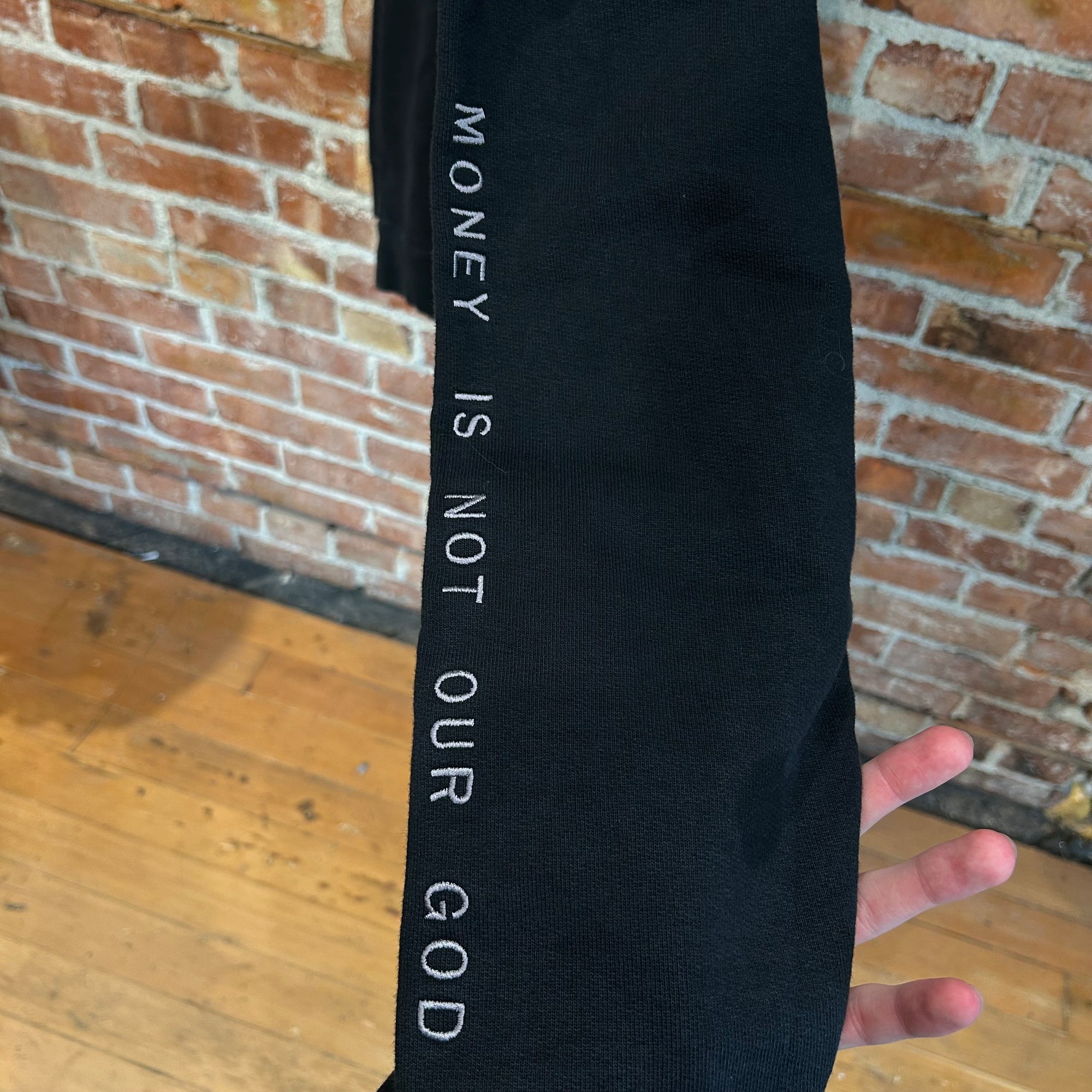 NEIGHBORHOOD HEAVY MONEY IS NOT OUR GOD CREWNECK ‘BLACK’