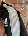 NEEDLES X AWGE TRACK PANTS ‘BLACK/SILVER’