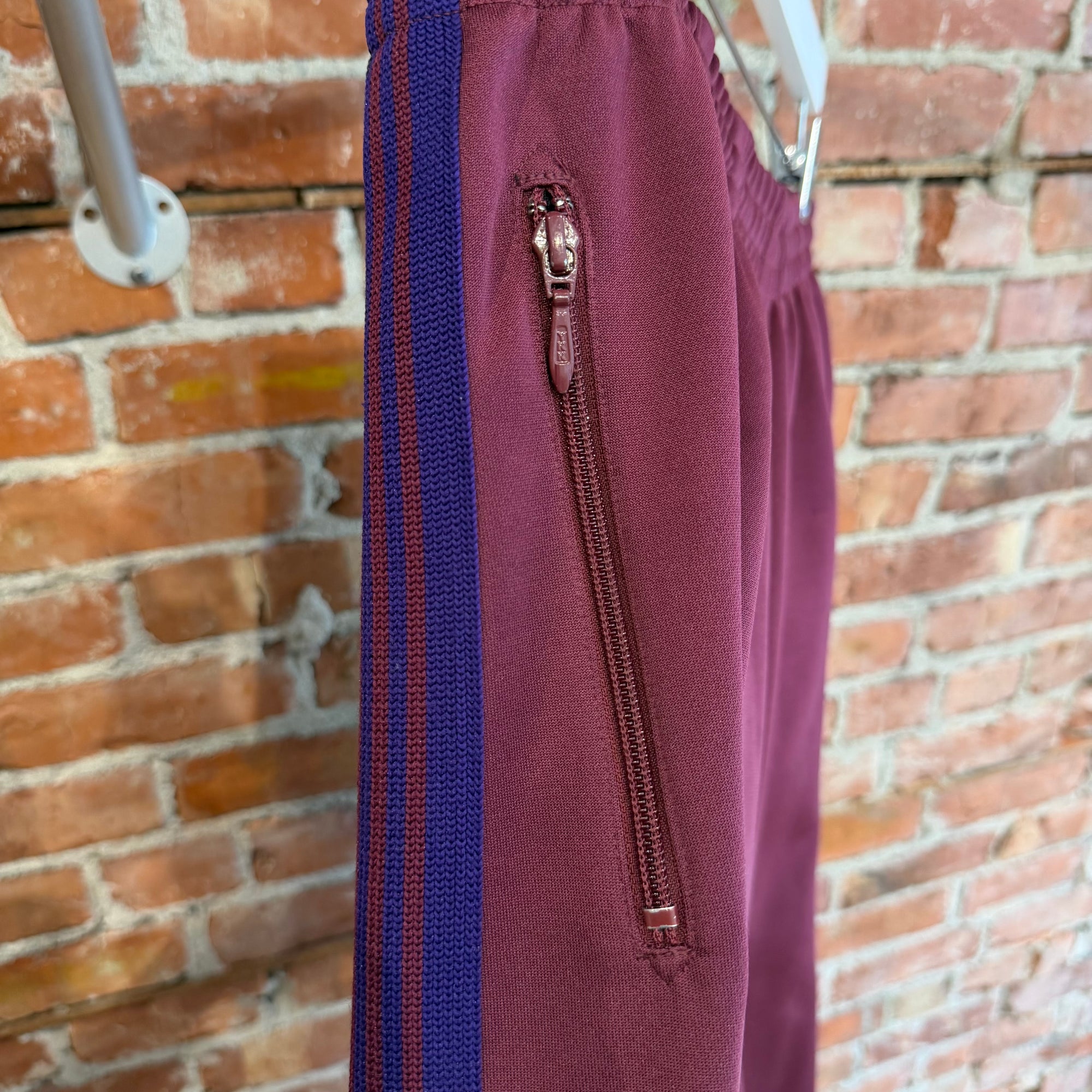 NEEDLES WIDE HD TRACK PANTS ‘MAROON/PURPLE’